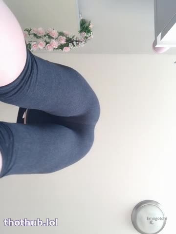 Emi squats in yoga suit over camera