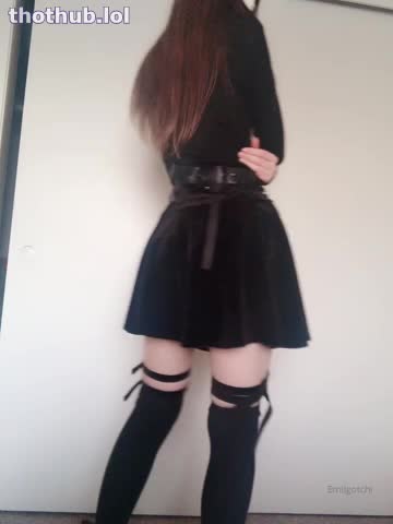 Emi in black posing