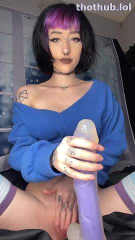 horny gothic girl plays with her long dildo on the bed